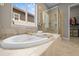Tranquil main bathroom showcasing a soaking tub with a view and a separate shower at 8056 Piney River Ave, Littleton, CO 80125