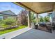 Covered patio with outdoor seating and views of the landscaped backyard, ideal for relaxing or entertaining at 8056 Piney River Ave, Littleton, CO 80125
