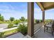 A peaceful front porch with comfortable seating, offering a relaxing outdoor space to enjoy the surrounding greenery at 8056 Piney River Ave, Littleton, CO 80125