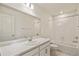 A modern bathroom features neutral tile, a vanity with sink, and a shower/tub combo at 13458 E 111Th Ave, Commerce City, CO 80022