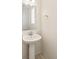 Charming half-bathroom with a pedestal sink, a classic mirror, and a neutral color palette at 13458 E 111Th Ave, Commerce City, CO 80022