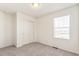 A cozy bedroom features neutral carpet, white walls, a closet, and a window at 13458 E 111Th Ave, Commerce City, CO 80022