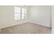 A bright bedroom showcasing neutral carpeting and sun-filled windows with blinds at 13458 E 111Th Ave, Commerce City, CO 80022