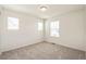 A bright bedroom features neutral carpet, white walls, and sunny windows at 13458 E 111Th Ave, Commerce City, CO 80022
