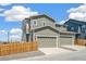 Exterior of a two-story home with a three-car garage and fenced front yard at 13458 E 111Th Ave, Commerce City, CO 80022