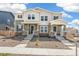 Inviting townhome exterior featuring modern architecture with stone accents and landscaped front yard at 13458 E 111Th Ave, Commerce City, CO 80022