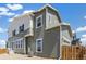 Side view of a two-story house featuring green siding and white trim at 13458 E 111Th Ave, Commerce City, CO 80022