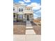 Charming townhome exterior with stone accents, inviting front porch, and well-maintained landscaping at 13458 E 111Th Ave, Commerce City, CO 80022