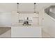 Bright kitchen featuring white cabinetry, stainless appliances, large island with double sink, and overhead lighting at 13458 E 111Th Ave, Commerce City, CO 80022