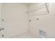 Bright laundry room with tile floor, a wire rack, and utility connections at 13458 E 111Th Ave, Commerce City, CO 80022