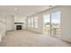 Bright living room featuring a cozy fireplace, large windows, and a seamless flow to the outdoor space at 13458 E 111Th Ave, Commerce City, CO 80022