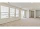 Bright and airy living room boasting plush carpeting, large windows, and a seamless flow to the outdoors at 13458 E 111Th Ave, Commerce City, CO 80022