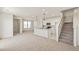 Bright, open-concept living space featuring plush carpeting, a modern kitchen, and abundant natural light at 13458 E 111Th Ave, Commerce City, CO 80022