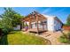 Home's exterior features a deck with pergola and landscaped yard at 11228 W Progress Ave, Littleton, CO 80127