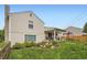 Wide shot of the spacious backyard with a covered patio, green lawn and beautiful landscaping at 7465 S Ivy Way, Centennial, CO 80112