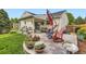 Beautiful backyard patio with red rocking chairs, overhead umbrella, and various potted plants at 7465 S Ivy Way, Centennial, CO 80112