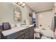 Updated bathroom with a spacious vanity, modern fixtures, and a tub/shower combination at 7465 S Ivy Way, Centennial, CO 80112