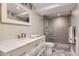 Modern bathroom featuring a vanity, a frameless glass shower, and decorative tile flooring at 7465 S Ivy Way, Centennial, CO 80112