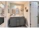 Well-lit bathroom with a modern vanity, stylish mirror, and decorative accents at 7465 S Ivy Way, Centennial, CO 80112