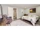 Relaxing bedroom featuring a comfortable bed, accent wall art, and a cozy chair at 7465 S Ivy Way, Centennial, CO 80112