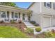 Inviting front porch featuring charming chairs, complemented by meticulously maintained landscaping and a brick-accented facade at 7465 S Ivy Way, Centennial, CO 80112