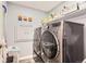 Efficient laundry room with modern appliances, shelving, and ample storage space at 7465 S Ivy Way, Centennial, CO 80112