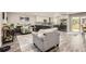 Open-concept living space featuring a modern kitchen with stainless steel appliances, flowing seamlessly into a cozy living area at 7465 S Ivy Way, Centennial, CO 80112