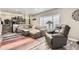 Inviting living room with a modern sectional sofa, a fireplace, and a large window for natural light at 7465 S Ivy Way, Centennial, CO 80112