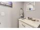Modern powder room featuring a stylish vanity with a sleek countertop, complemented by contemporary fixtures and décor at 7465 S Ivy Way, Centennial, CO 80112
