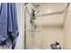 Tiled shower with a glass door, featuring a modern showerhead and a built-in shelf at 7465 S Ivy Way, Centennial, CO 80112