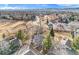 Wide aerial view of a neighborhood with winding roads, fields and the mountains in the background at 8348 W 90Th Ave, Broomfield, CO 80021