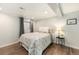 Cozy bedroom with wood-look flooring and a decorative accent lamp on a bedside table at 8348 W 90Th Ave, Broomfield, CO 80021