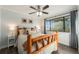 Comfortable bedroom featuring a wooden frame bed, ceiling fan, and natural light from the window at 8348 W 90Th Ave, Broomfield, CO 80021