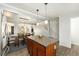 Bright kitchen with an island featuring barstool seating and a view of the adjacent dining area at 8348 W 90Th Ave, Broomfield, CO 80021