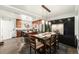 Open kitchen and dining area, complete with stainless steel appliances, dark cabinets and a modern table at 8348 W 90Th Ave, Broomfield, CO 80021