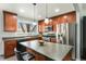 Well-equipped kitchen featuring stainless steel appliances, wood cabinets, and kitchen island with seating at 8348 W 90Th Ave, Broomfield, CO 80021