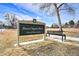 Image of a neighborhood park sign, Dover Square Park, with a bench and open field at 8348 W 90Th Ave, Broomfield, CO 80021