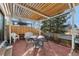 Outdoor patio area featuring brick flooring, a pergola, and outdoor seating, perfect for entertaining at 8348 W 90Th Ave, Broomfield, CO 80021