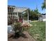 Backyard view with a wooden pergola, storage shed, lush lawn and landscaping at 9486 Pelon Dr, Denver, CO 80260