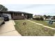 Charming brick home with front yard, landscaping, porch and a concrete walkway at 9486 Pelon Dr, Denver, CO 80260
