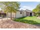 View of the backyard with well maintained lawn, access to a covered patio, garage and gated yard at 306 E Iowa Ave, Berthoud, CO 80513