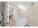 Updated bathroom with a tiled floor, granite vanity and stylish mirror with modern lighting at 306 E Iowa Ave, Berthoud, CO 80513