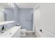 Stylish bathroom with modern fixtures, patterned tile, and bathtub with shower at 306 E Iowa Ave, Berthoud, CO 80513
