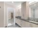 Modern bathroom featuring gray countertop, double sinks and frameless shower at 306 E Iowa Ave, Berthoud, CO 80513