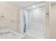 Updated bathroom with a tiled shower and tub, along with a modern sink and vanity at 306 E Iowa Ave, Berthoud, CO 80513