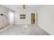 Bright bedroom features light walls, a ceiling fan and a decorative accent wall at 306 E Iowa Ave, Berthoud, CO 80513