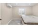 Bedroom with a comfortable mattress, carpeted floors and mini-split air conditioning unit at 306 E Iowa Ave, Berthoud, CO 80513