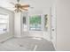 Bright bedroom featuring large bay windows, neutral carpet, and ceiling fan at 306 E Iowa Ave, Berthoud, CO 80513