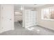 Bonus room with carpeted floors, built in storage and bonus shelving, and natural light at 306 E Iowa Ave, Berthoud, CO 80513