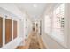 Long hallway with natural light and coat rack at 306 E Iowa Ave, Berthoud, CO 80513